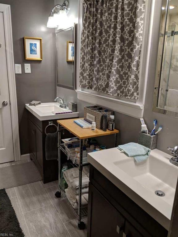 bathroom featuring vanity and a shower