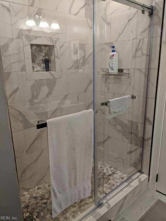 bathroom with a shower with shower door