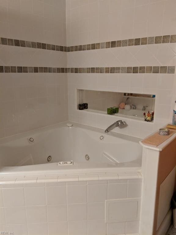 bathroom with a relaxing tiled tub