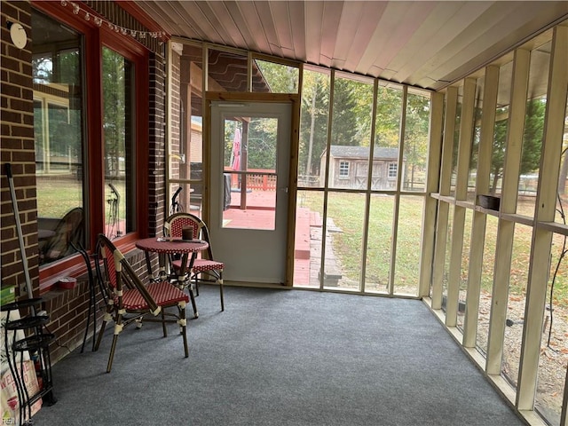 unfurnished sunroom featuring wooden ceiling and a healthy amount of sunlight