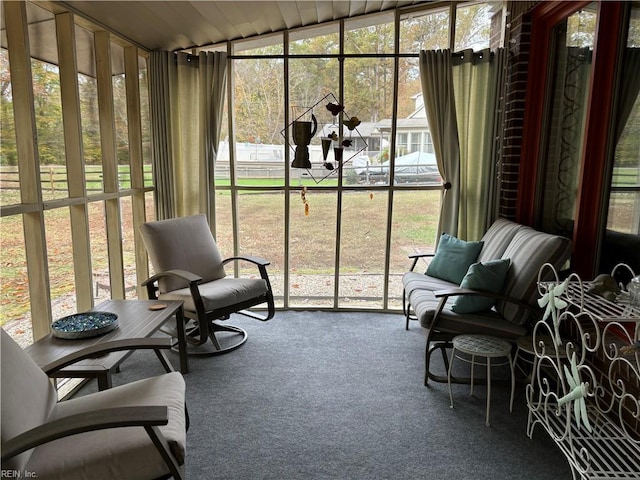 sunroom featuring vaulted ceiling