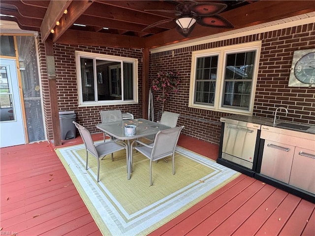 wooden terrace featuring ceiling fan and sink