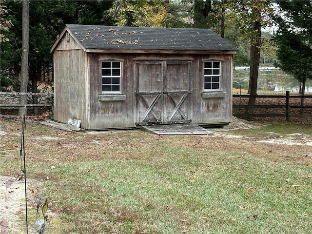 view of outdoor structure featuring a lawn