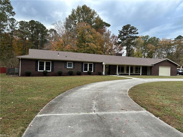 single story home featuring a garage and a front lawn