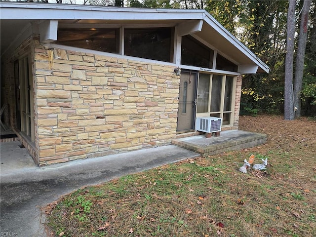 view of outbuilding featuring a sunroom