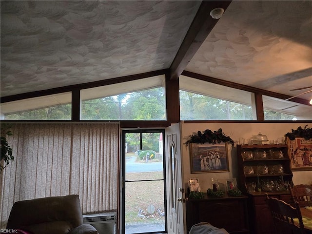 doorway featuring ceiling fan, cooling unit, and vaulted ceiling with beams