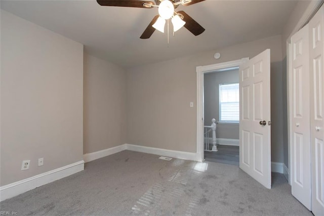 spare room featuring light carpet and ceiling fan