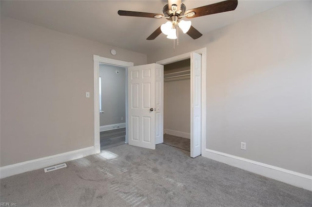 unfurnished bedroom featuring ceiling fan, a closet, and carpet