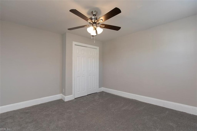 unfurnished bedroom with ceiling fan, a closet, and dark carpet