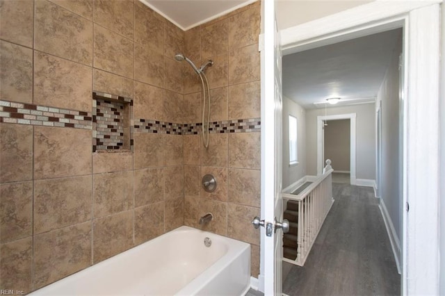 bathroom featuring tiled shower / bath combo and hardwood / wood-style floors