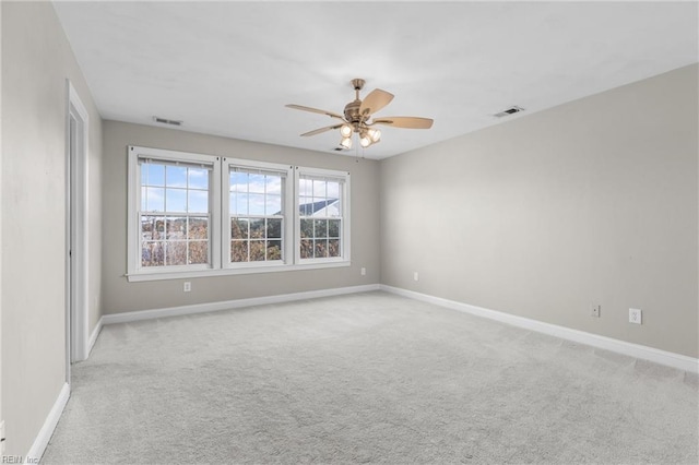 unfurnished room featuring light colored carpet and ceiling fan