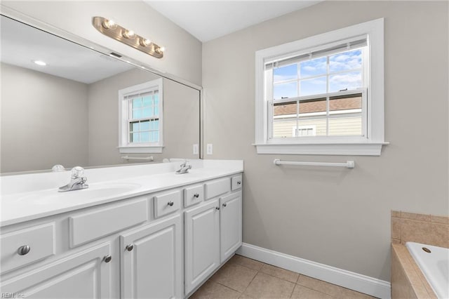 bathroom featuring tile patterned flooring, vanity, and a relaxing tiled tub