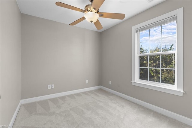 unfurnished room featuring light colored carpet and ceiling fan