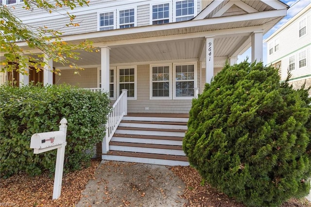 doorway to property featuring covered porch