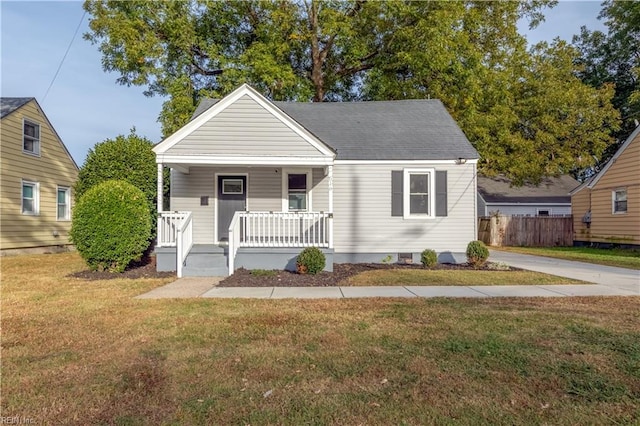 bungalow featuring a front lawn and covered porch