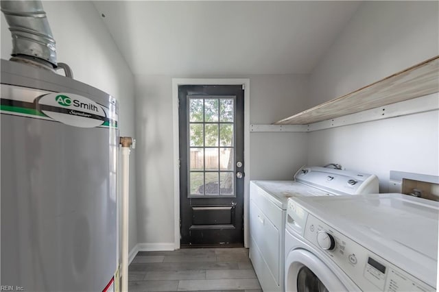 laundry room featuring washing machine and dryer and light hardwood / wood-style flooring