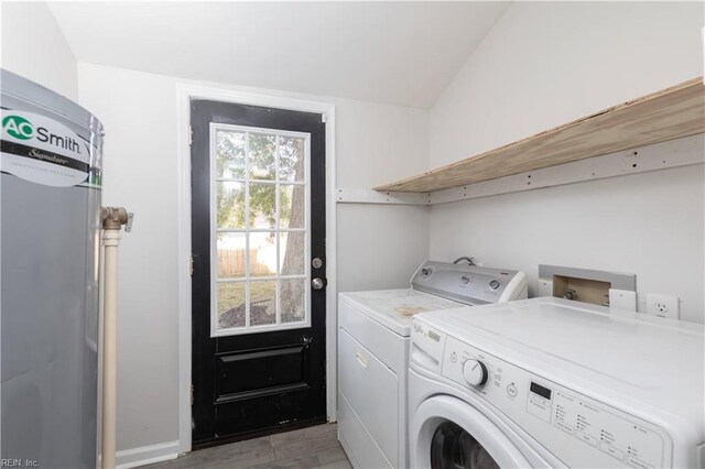 laundry area with light hardwood / wood-style flooring and washer and dryer