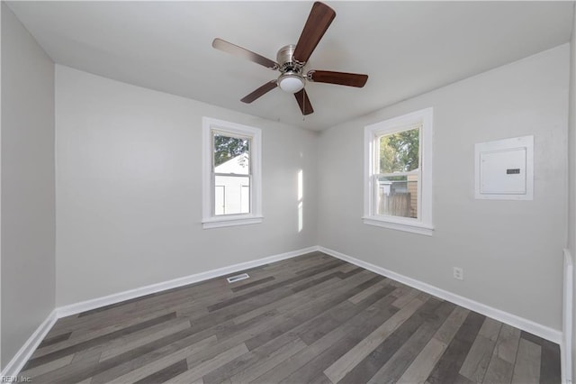 unfurnished room featuring electric panel, dark wood-type flooring, and ceiling fan