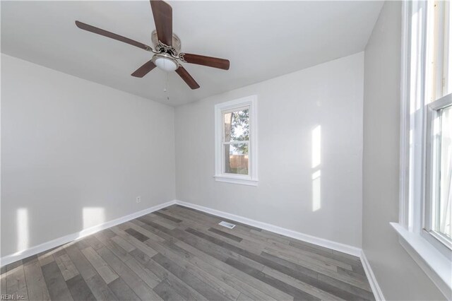 empty room with dark hardwood / wood-style flooring and ceiling fan