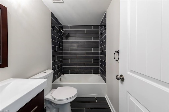 full bathroom featuring tiled shower / bath, vanity, and toilet