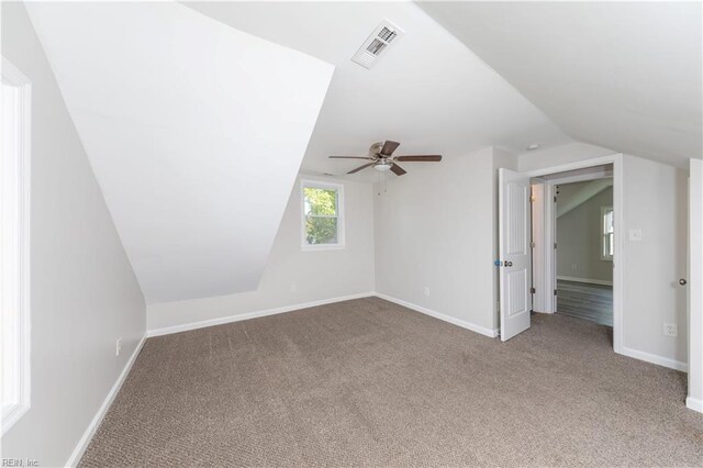 additional living space featuring vaulted ceiling, carpet flooring, and ceiling fan