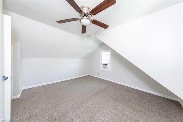 bonus room with vaulted ceiling and carpet floors