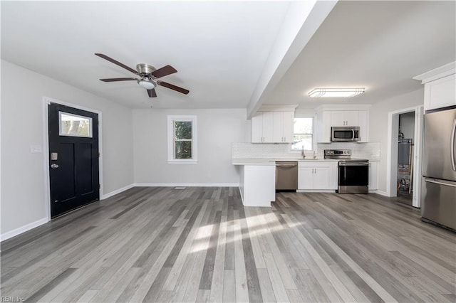 kitchen with white cabinetry, plenty of natural light, light wood-type flooring, and appliances with stainless steel finishes