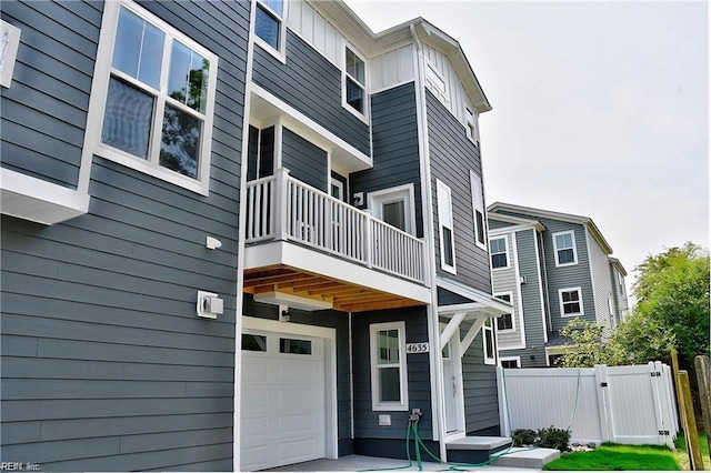 exterior space featuring a garage and a balcony