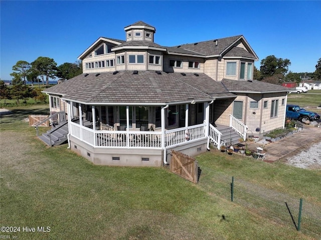 view of front of house featuring a front lawn and a wooden deck