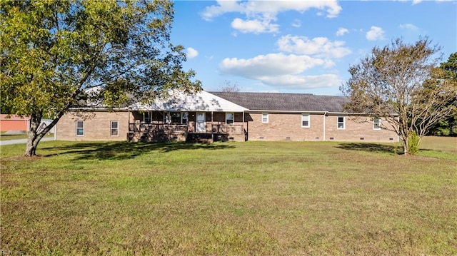 rear view of house featuring a lawn