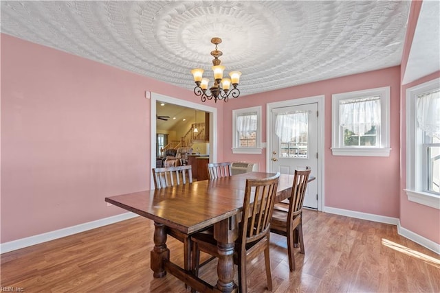 dining space with a chandelier and light hardwood / wood-style floors