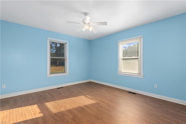 empty room featuring ceiling fan and dark hardwood / wood-style flooring