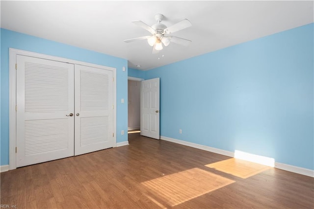 unfurnished bedroom featuring a closet, wood-type flooring, and ceiling fan