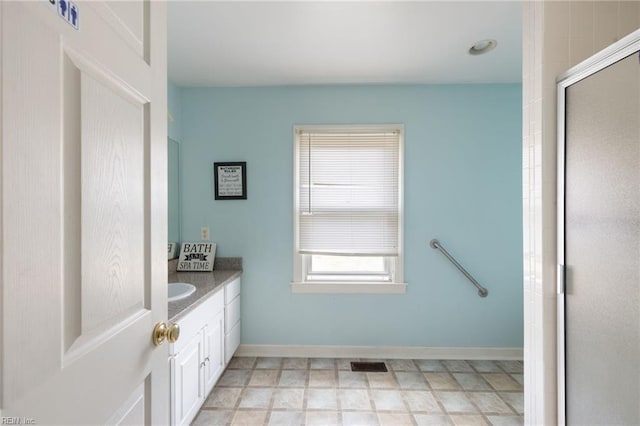 bathroom featuring an enclosed shower and vanity