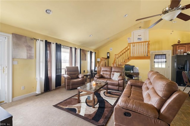 carpeted living room with lofted ceiling and ceiling fan