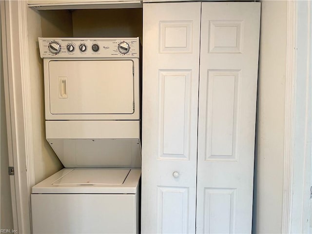 laundry area featuring laundry area and stacked washer and clothes dryer