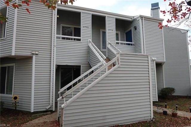 exterior space with a chimney and stairs