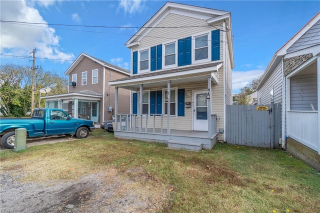 view of front of home with covered porch and a front lawn