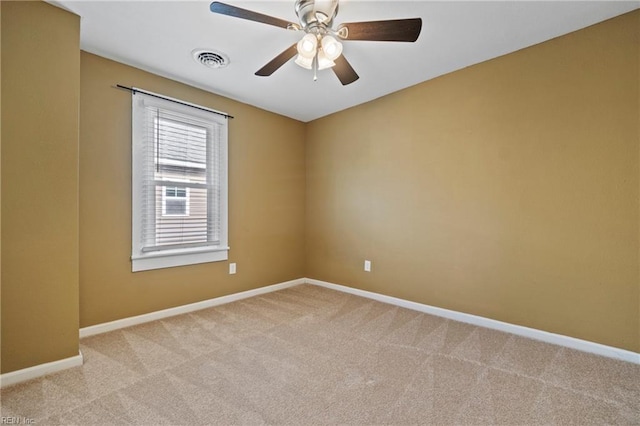 empty room featuring light colored carpet and ceiling fan