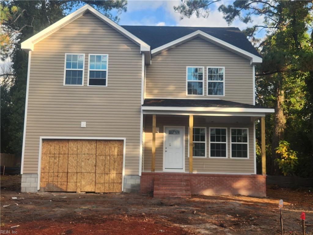 view of front of home with a garage and covered porch