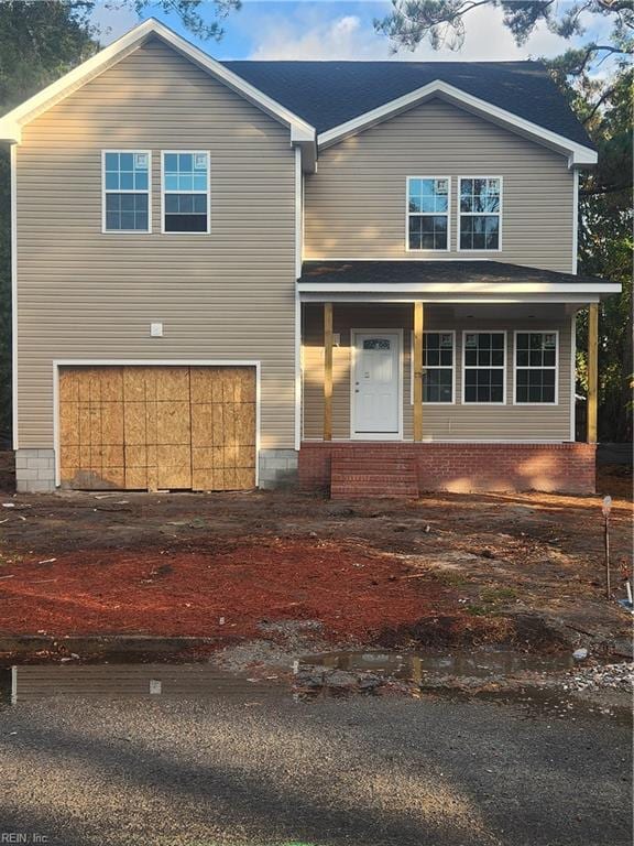 view of front of property with a garage and a porch