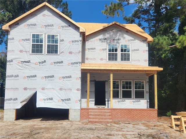 property in mid-construction featuring covered porch