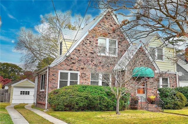 view of front of house featuring a front lawn, an outbuilding, and a garage