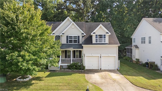 view of front of property featuring covered porch, a garage, and a front lawn