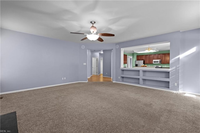 unfurnished living room with ceiling fan and carpet floors