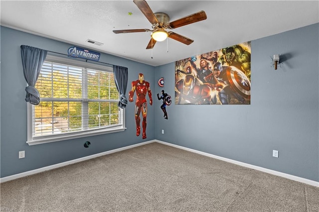 spare room with carpet flooring and ceiling fan