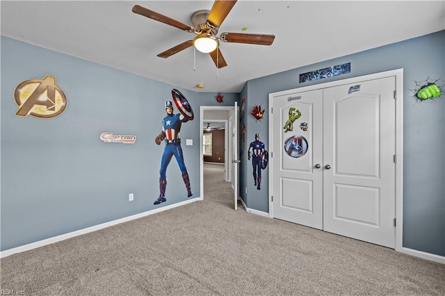 unfurnished bedroom featuring ceiling fan, light carpet, and a closet