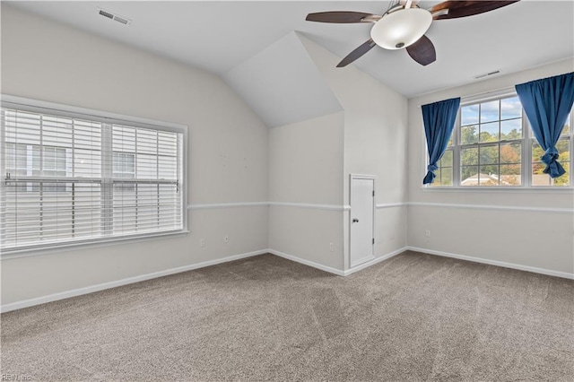 empty room with vaulted ceiling, carpet flooring, and ceiling fan