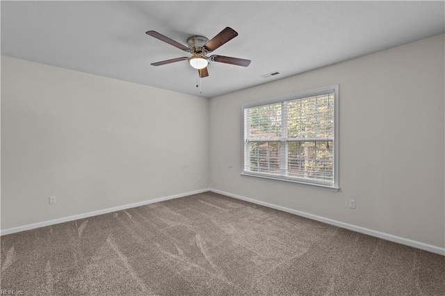 spare room featuring carpet and ceiling fan