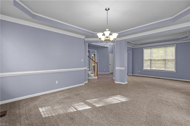 unfurnished room featuring ornamental molding and a raised ceiling